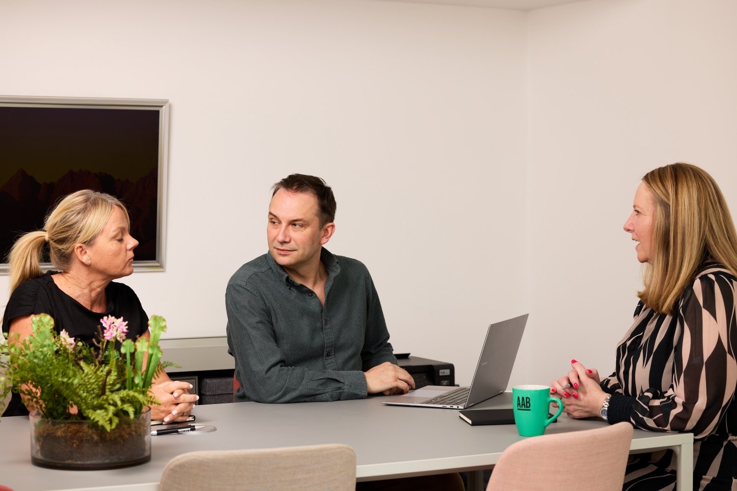 AAB team members sitting in a meeting room