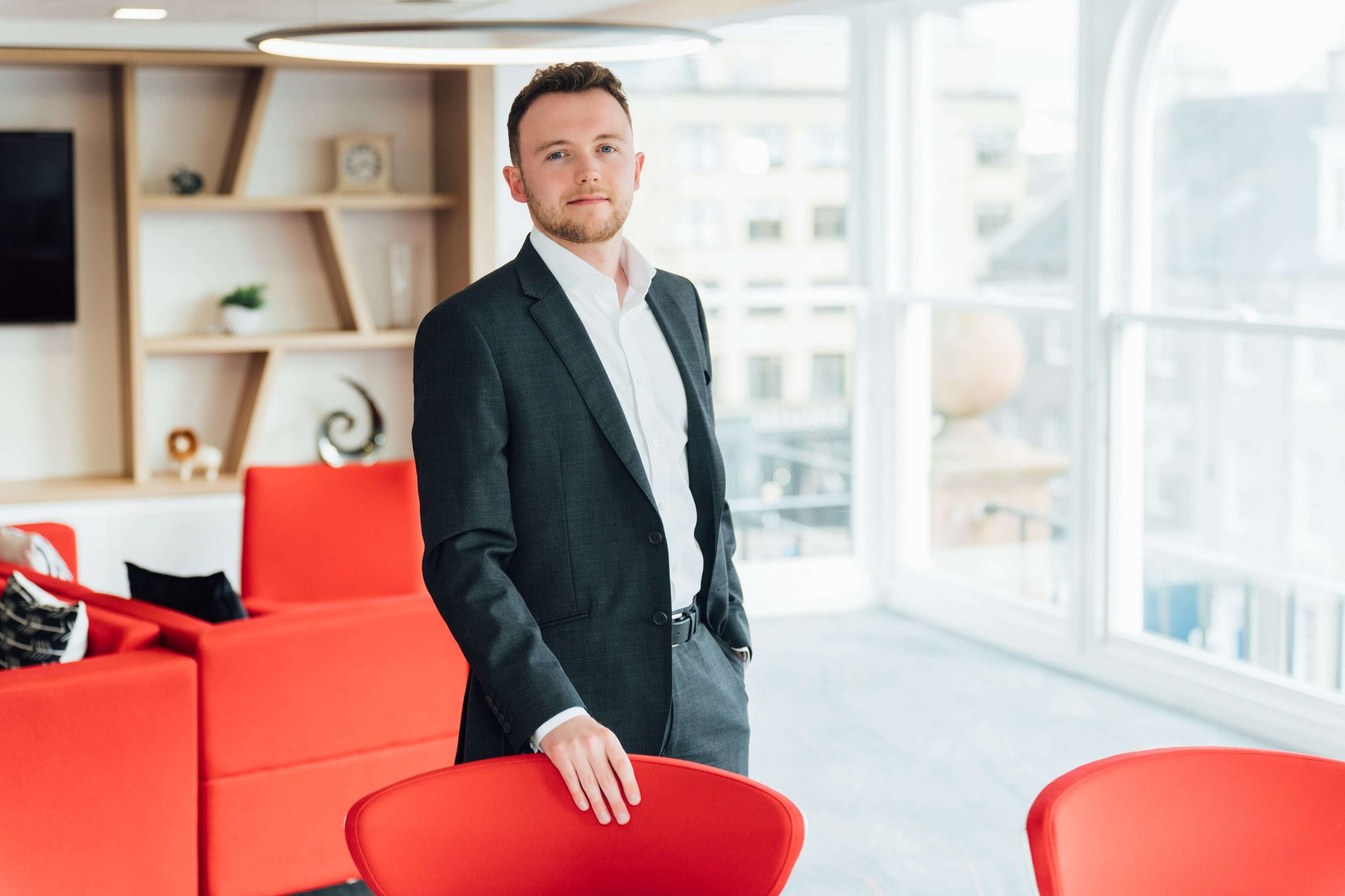 An image of Ben Weston smiling at the camera wearing a suit and shirt.