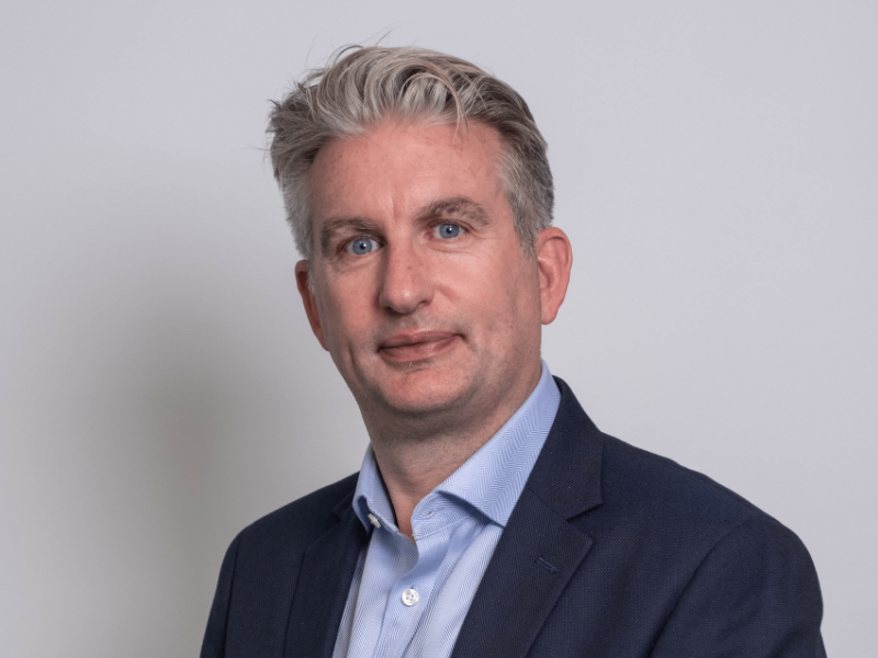 An image of Alan Campbell wearing a black blazer with a blue shirt. An image of Alan Campbell wearing a black blazer with a blue shirt.